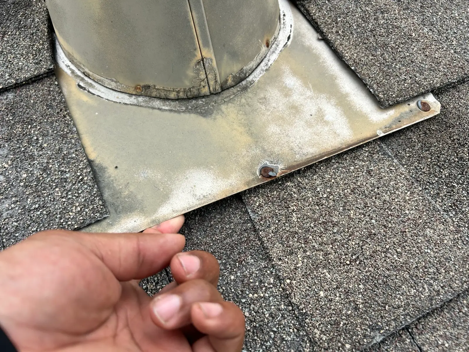 June 10. The pipe-jack flashing, corroded through. It lifted by hand.