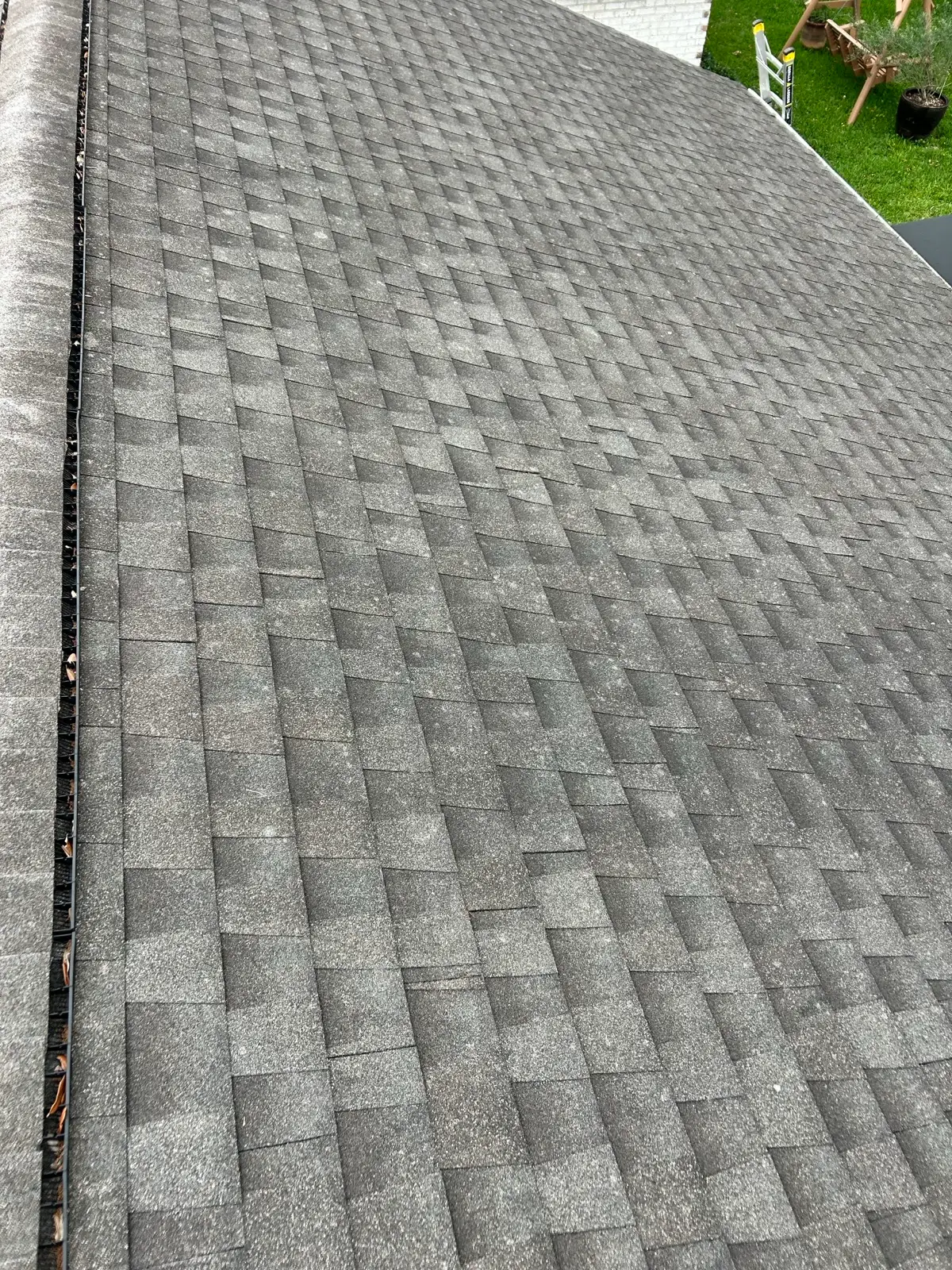June 10. The shingle field at the ridge — granule loss, debris in the gutter.
