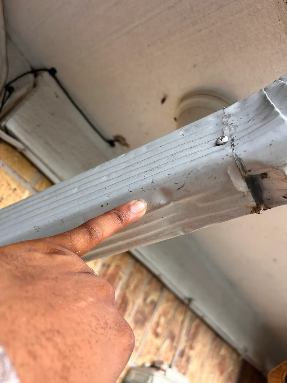 June 19. A storm-dented downspout, documented before replacement.