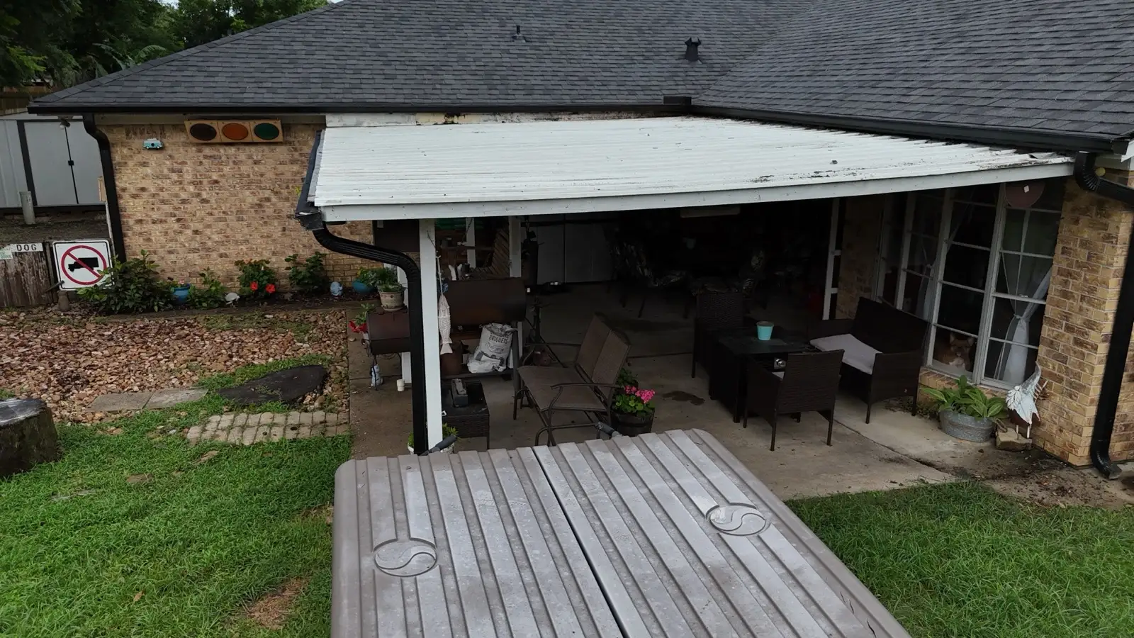 June 21. The original patio cover under the finished roof — replaced with 29-gauge metal the following week.