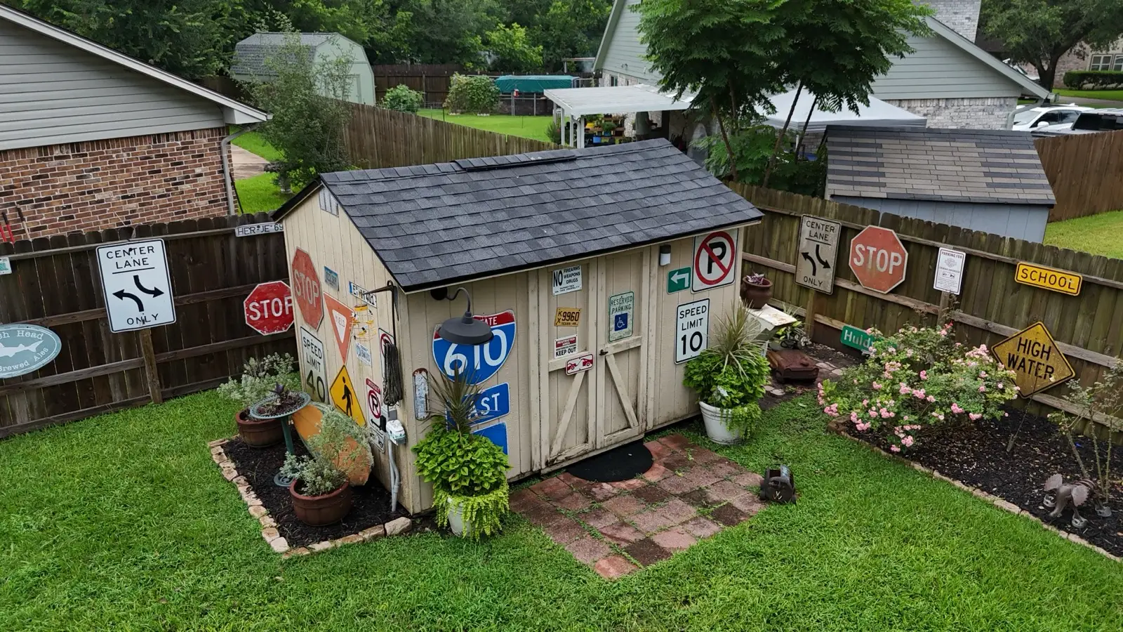June 21. The backyard shed — reshingled to match, road signs untouched.