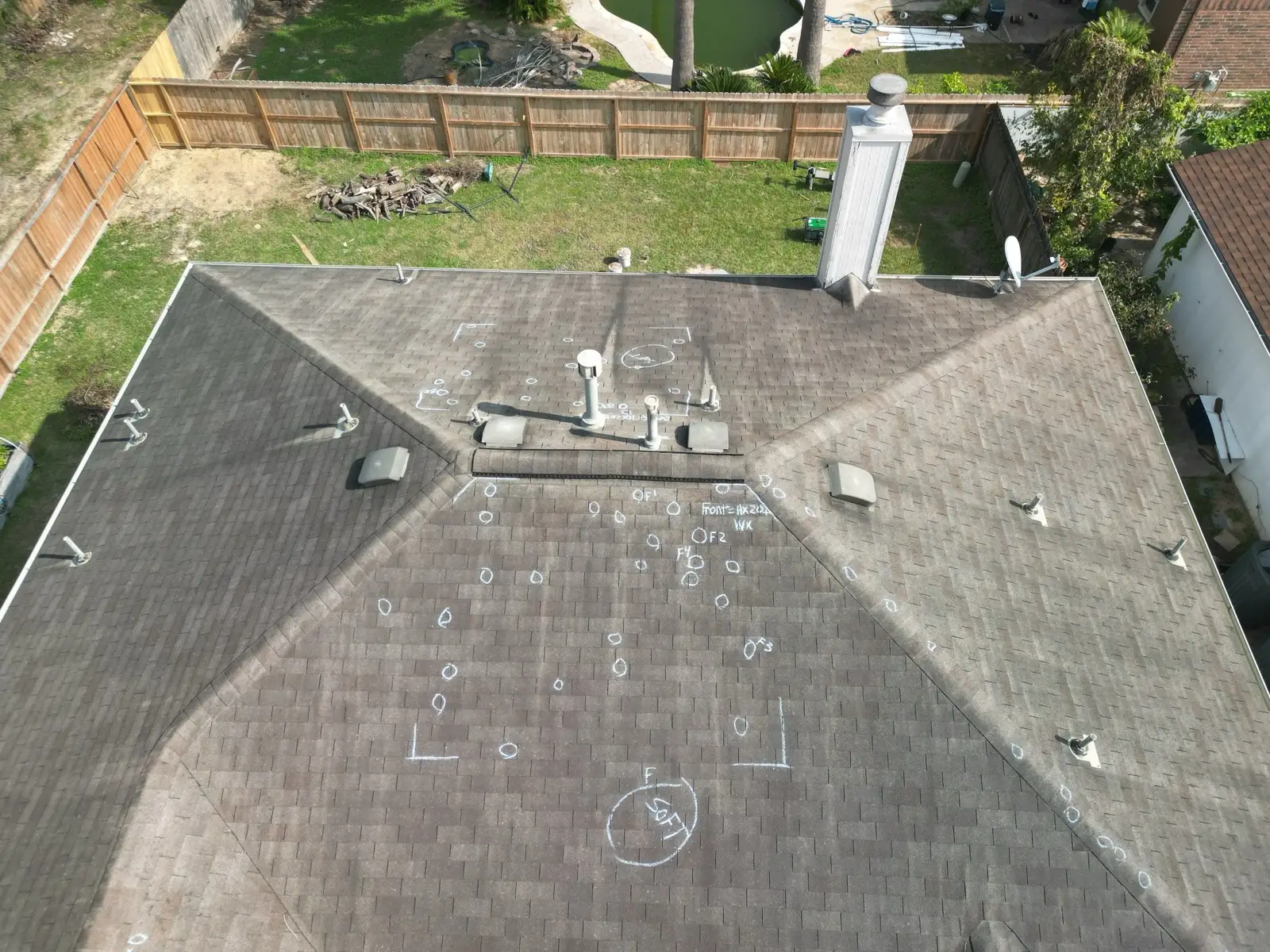 November 8. The old roof after the walk-through — inspection chalk across every slope.