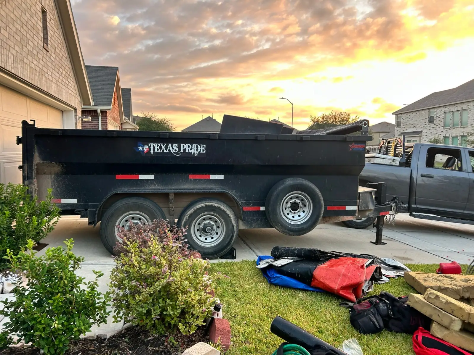 October 28, first light. The dump trailer and equipment staged in the driveway.