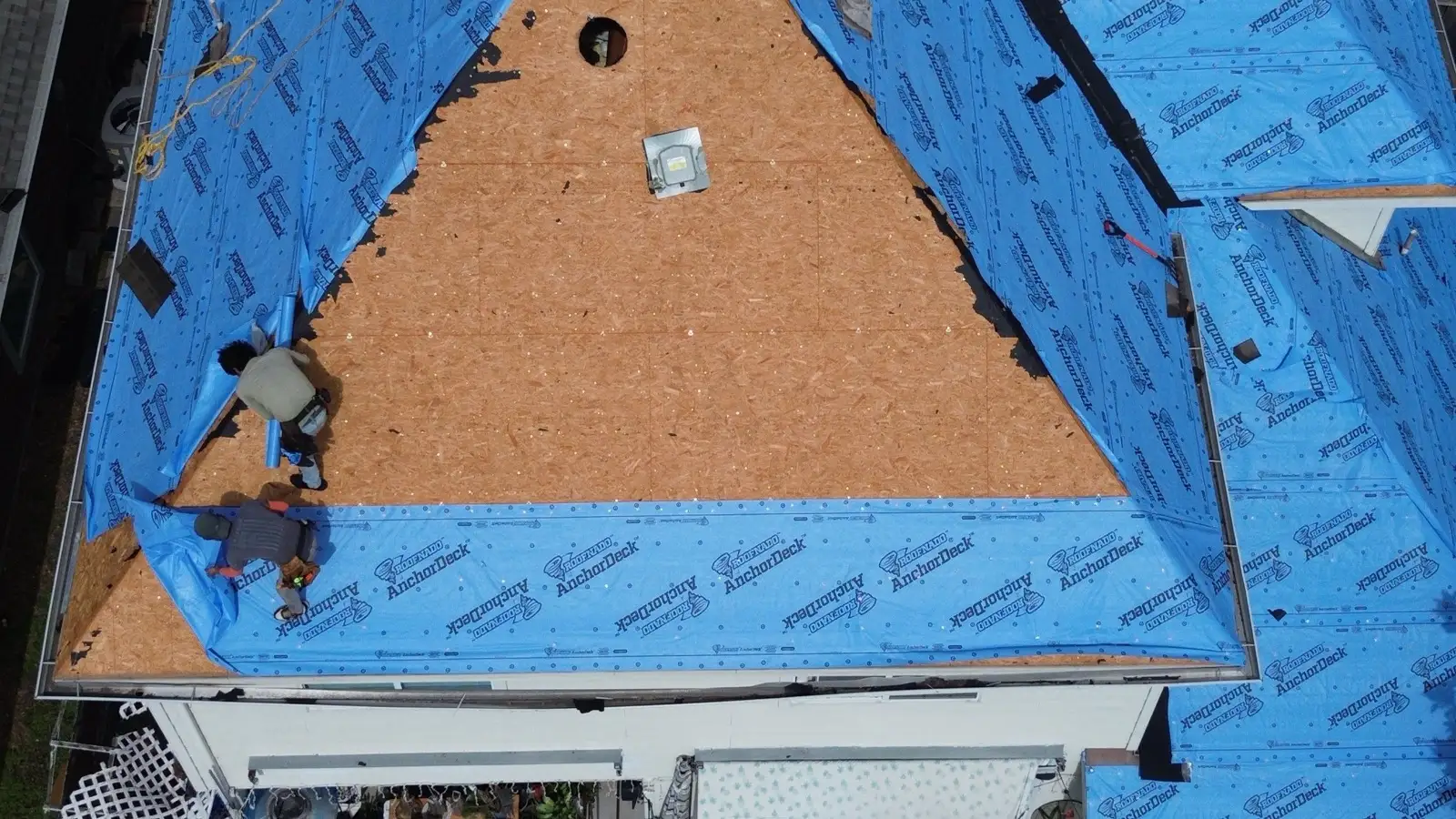 March 3. Down to the wood, underlayment being fitted around the open deck.