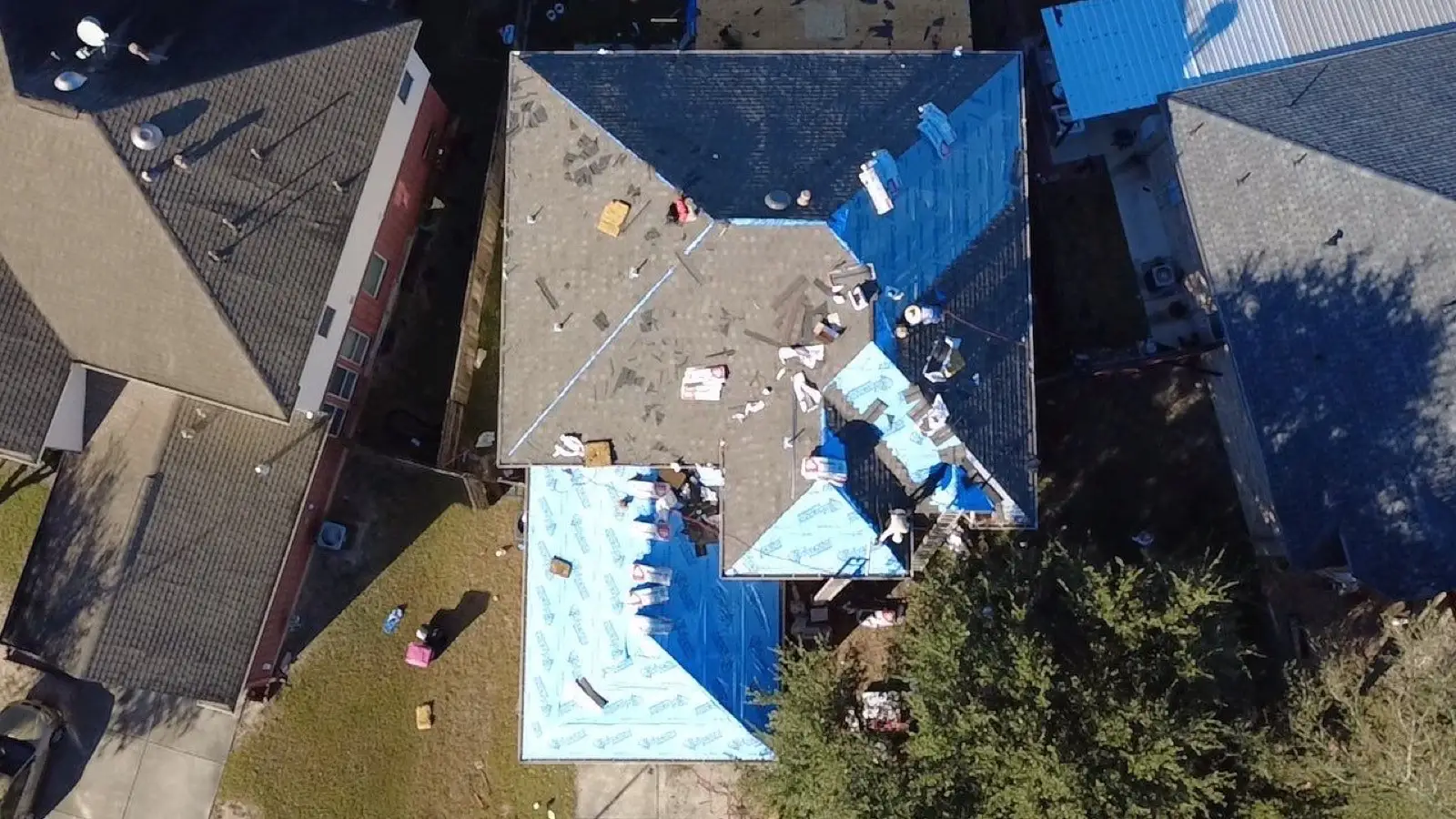 November 4. Overhead at the dry-in — CertainTeed synthetic down, shingles already started on one slope.