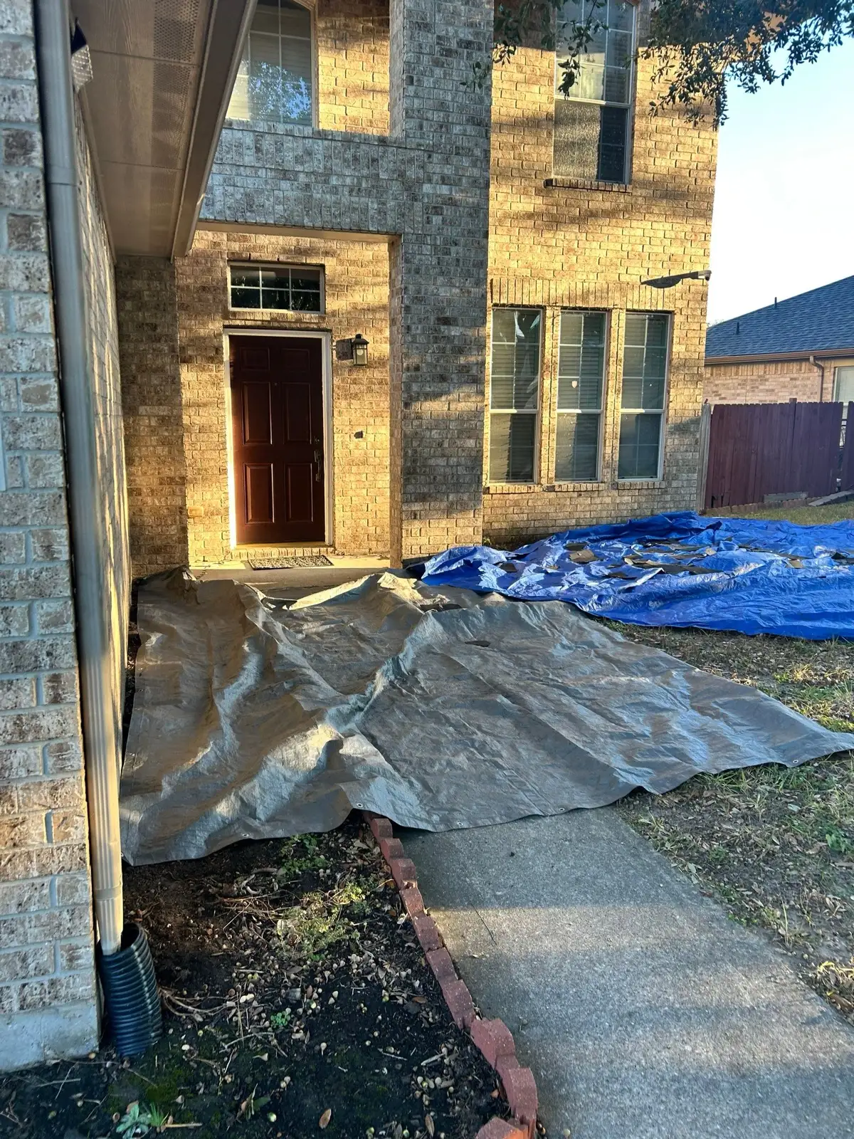 November 4. The walk to the front door under tarps before the roof came down around it.
