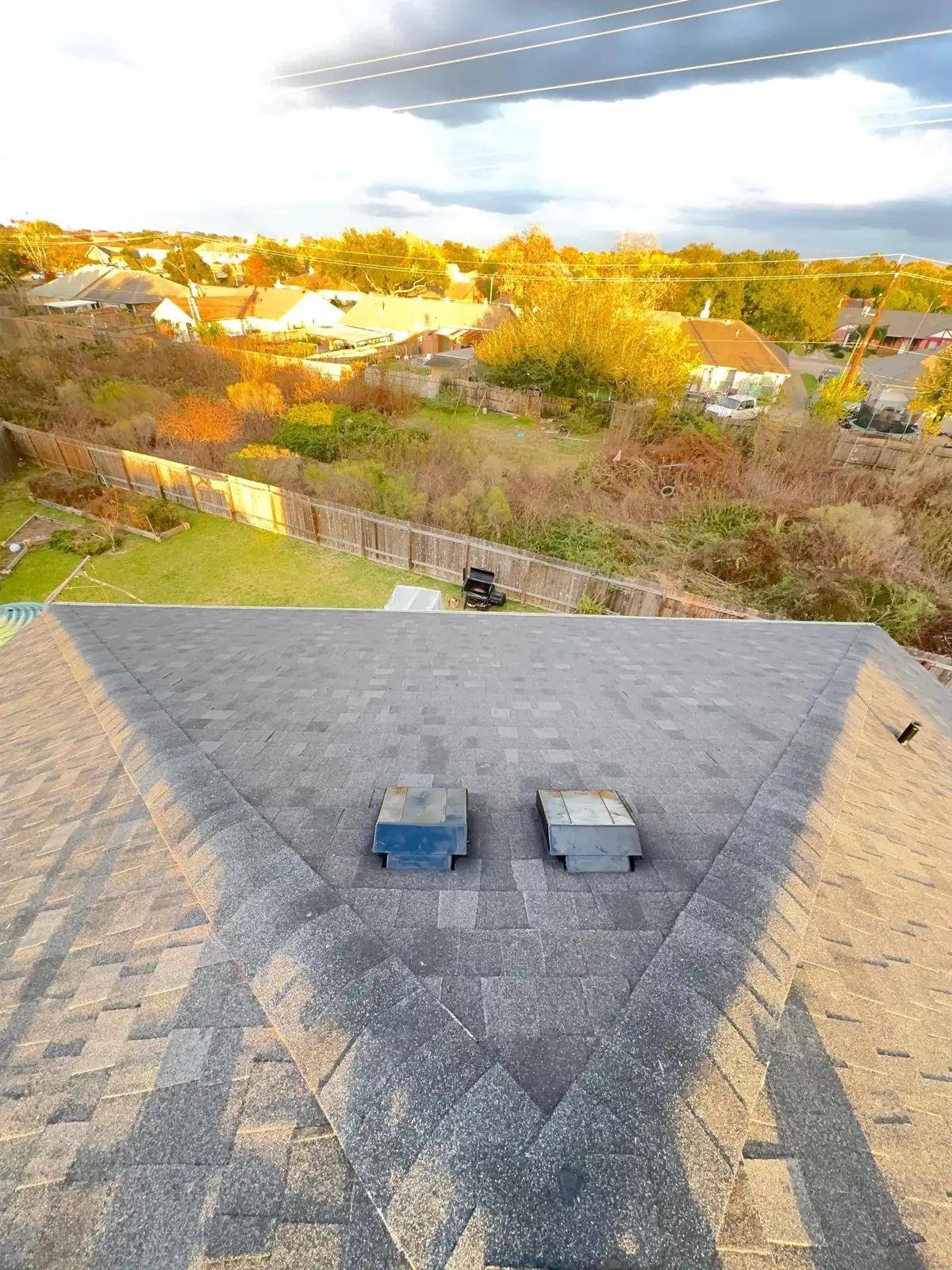December 12. The rear field and new box vents, last light over the neighborhood.