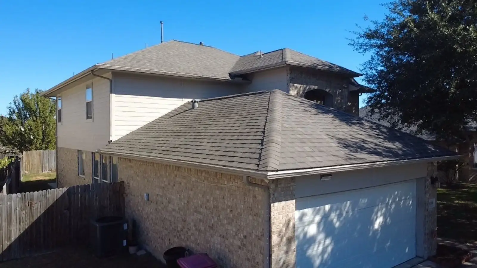 November 5. From the yard — new shingles over both stories, garage to ridge.