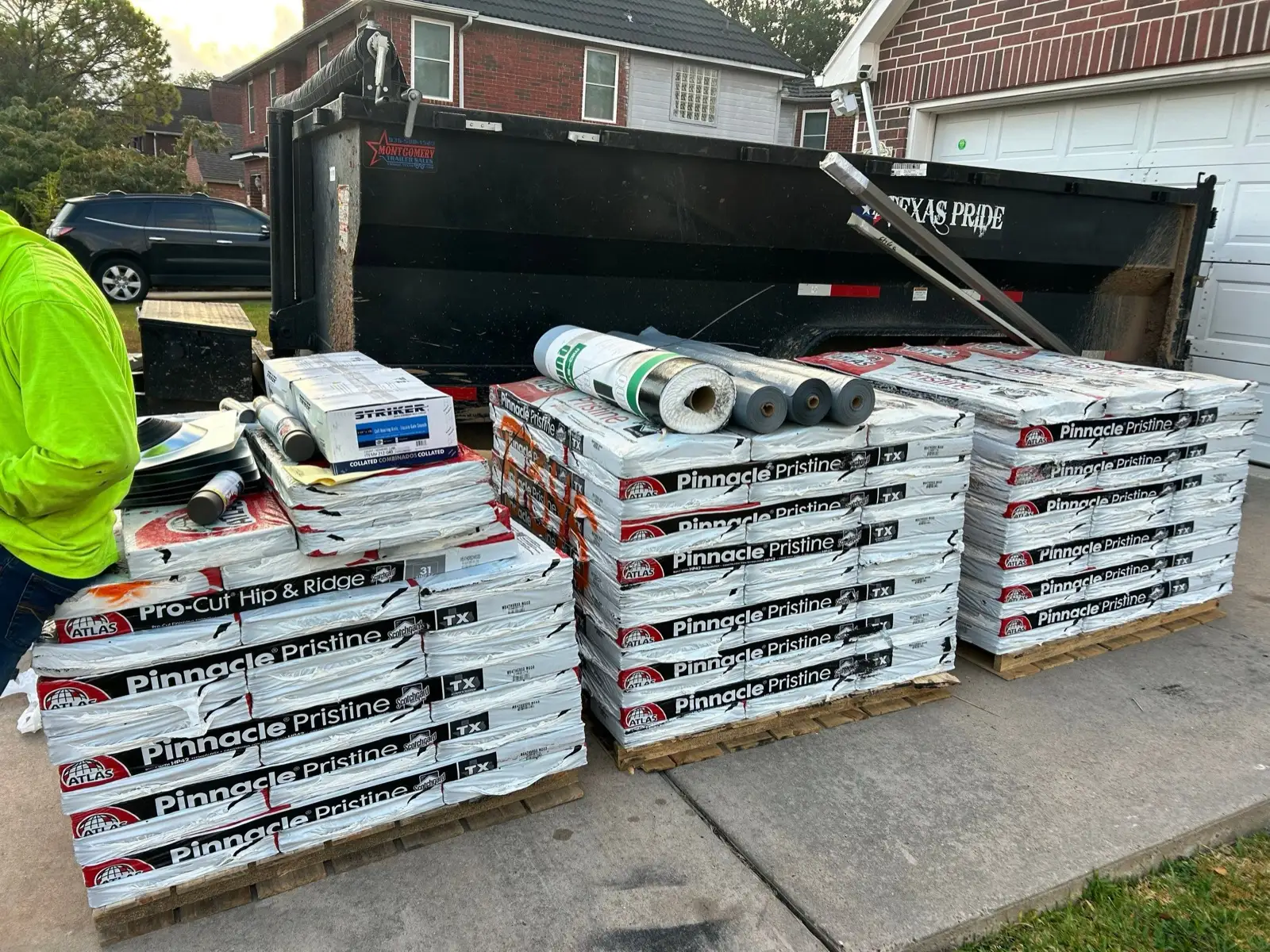 October 17. Shingles, hip-and-ridge, underlayment, and coil nails staged in the driveway.