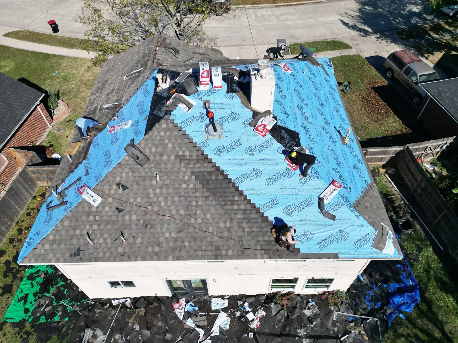 December 30. The midpoint — new shingles climbing over the underlayment, slope by slope.