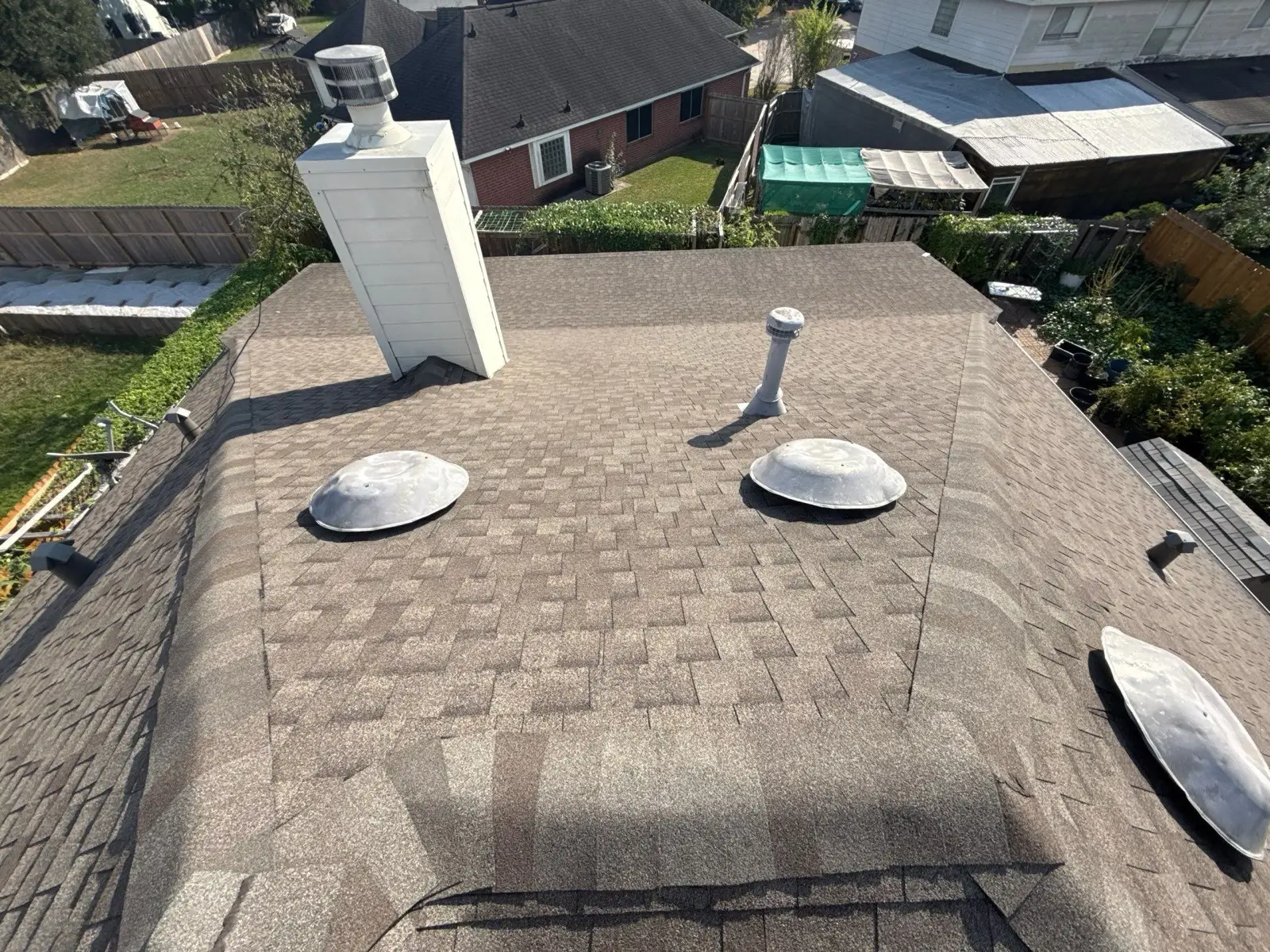 October 21. On the roof: the worn field around the chimney, turbine vents and cap in frame.