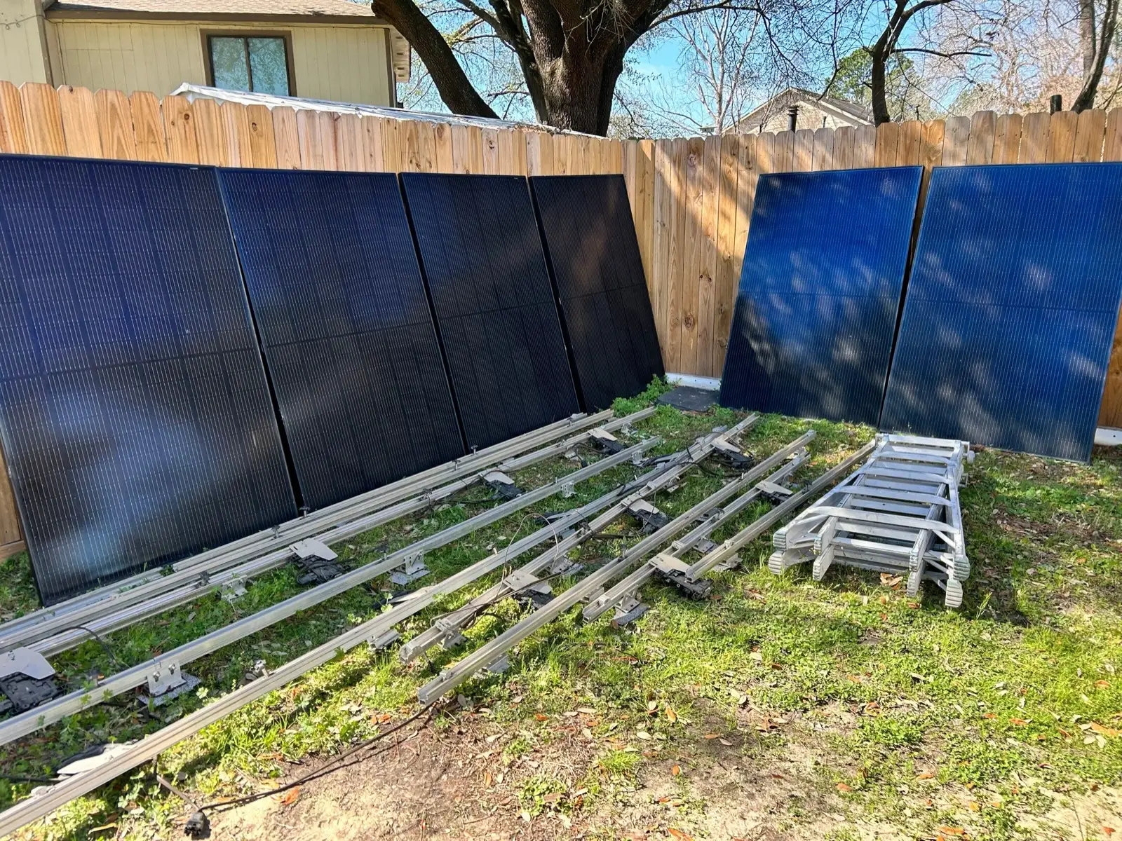 February 22. Every panel down and racked against the back fence, the rails stacked on the lawn.
