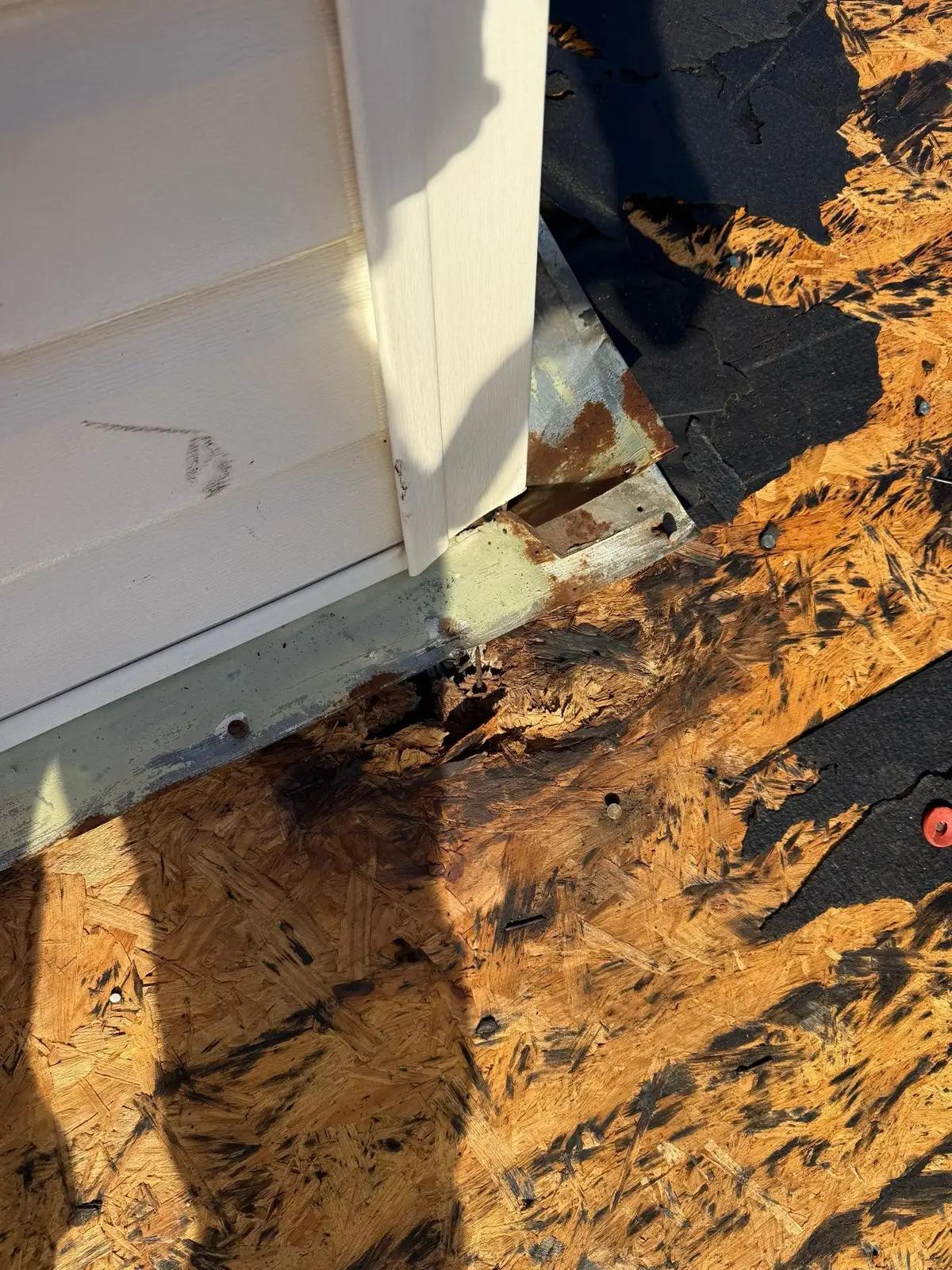 December 30. Rotted decking at the wall junction, exposed by tear-off.