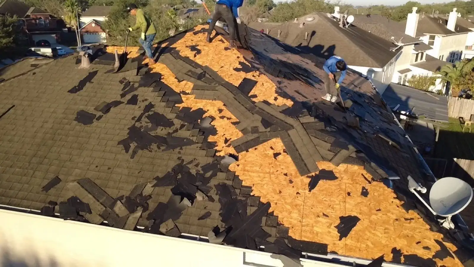 November 4. Shovels under the old shingles, decking already showing along the ridge.