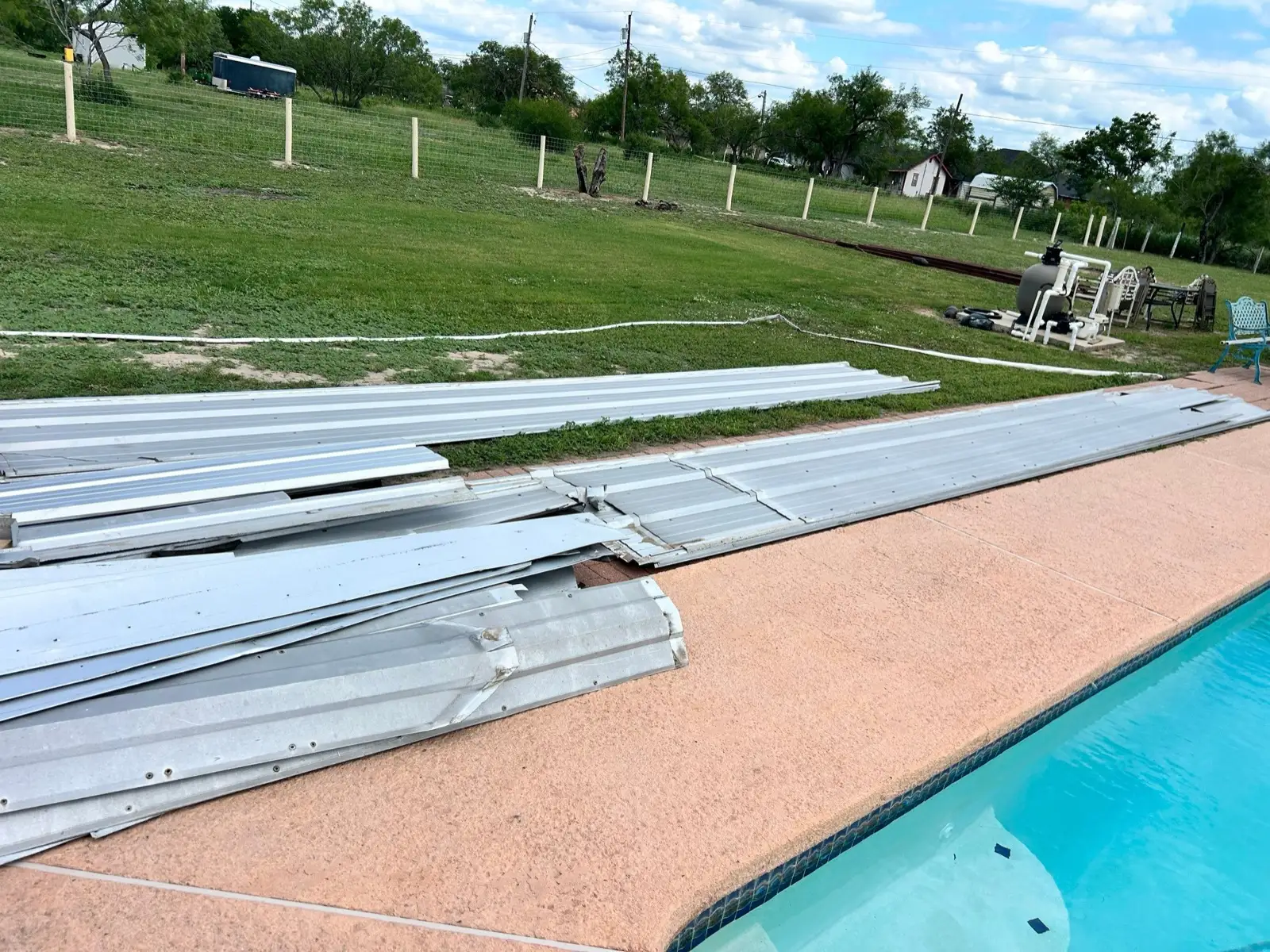 May 11. The original metal, off the house and stacked by the pool.