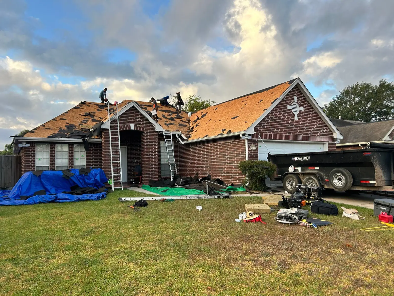 October 17. The front slopes going down to bare decking — tarps below catching the debris.