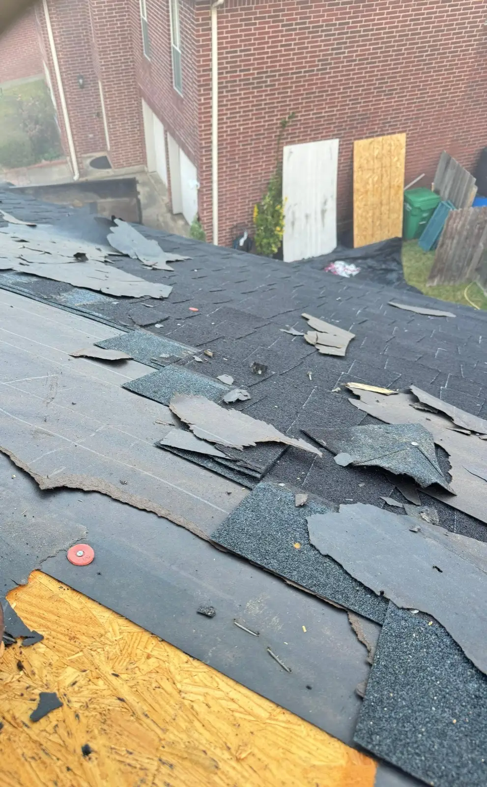 December 12. Tear-off underway — old shingles and felt peeled back to the deck.