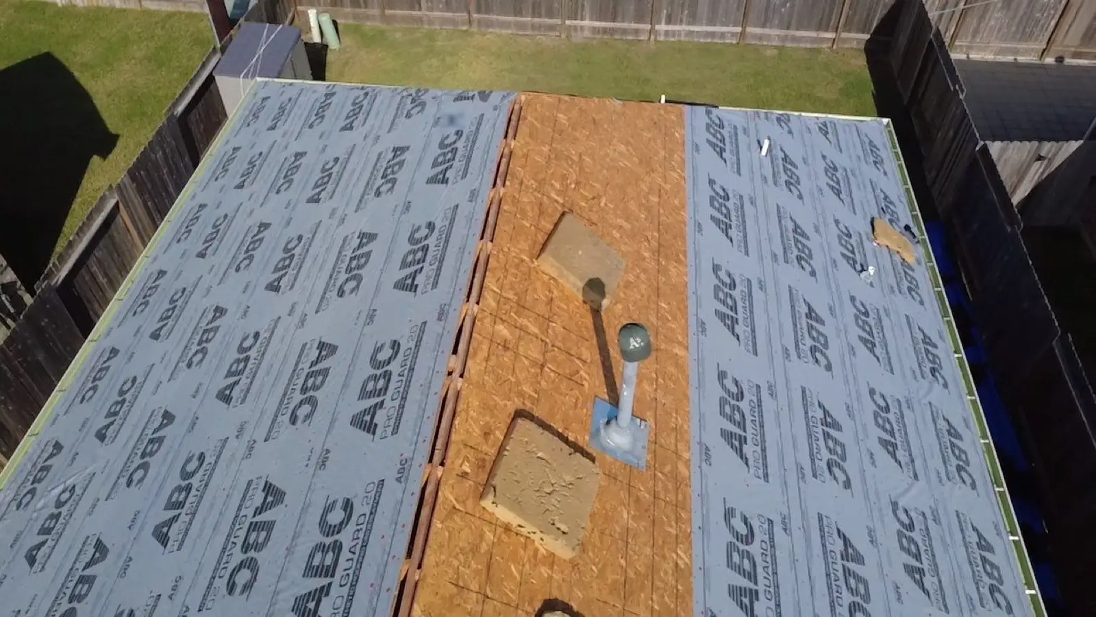 October 28. New synthetic underlayment working up both planes toward the open ridge.