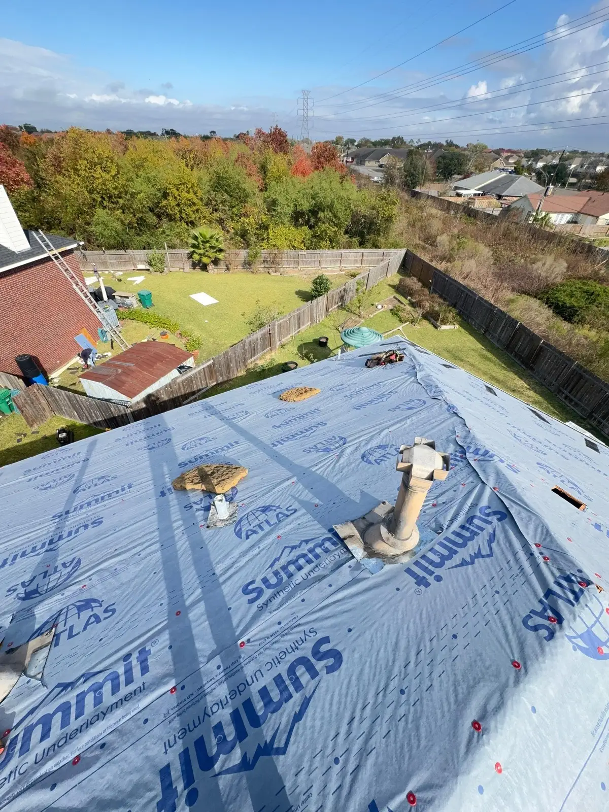 December 12. Atlas Summit synthetic underlayment fastened over the deck, cut around the stacks.