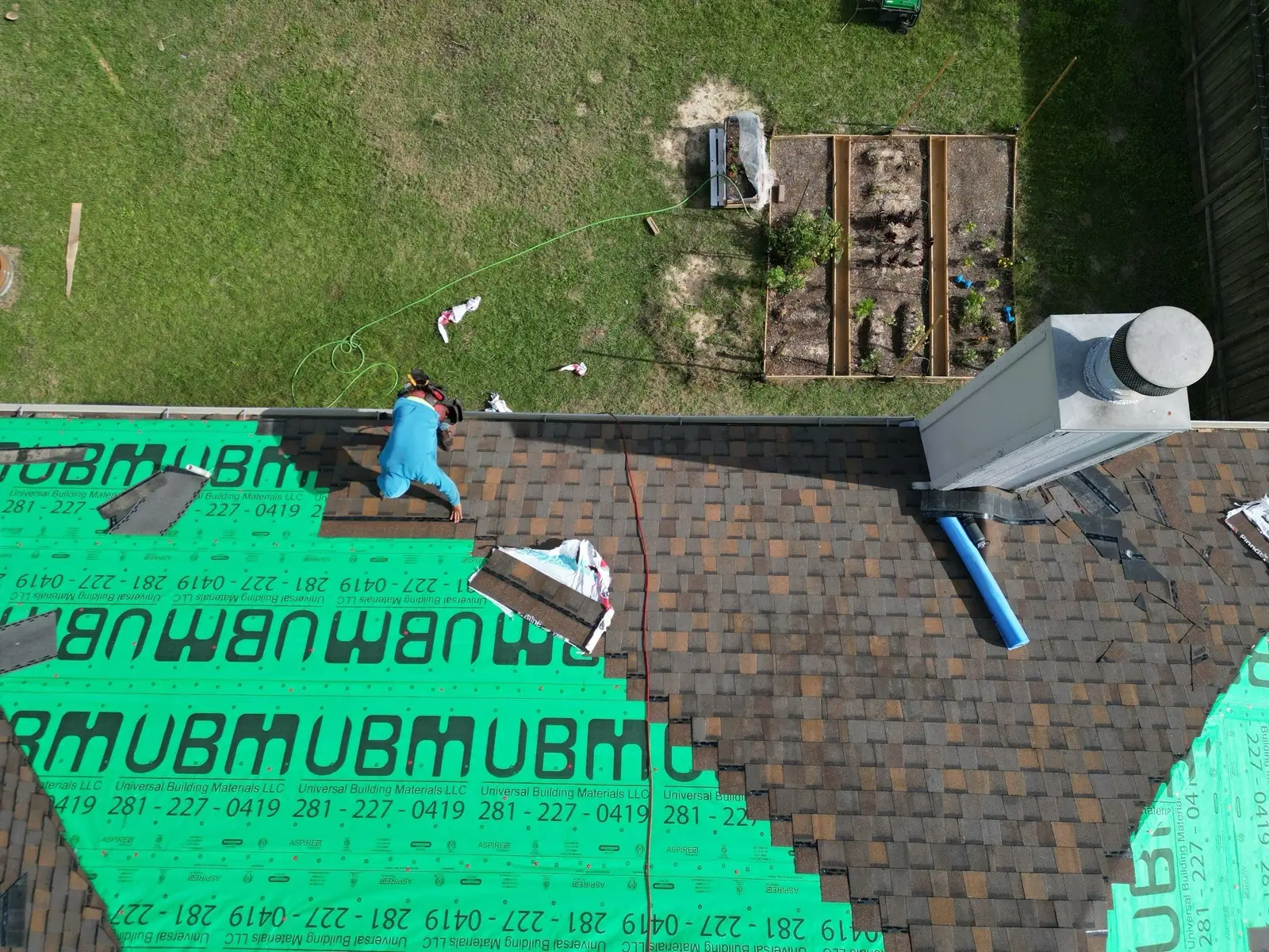 December 18. Straight down — new shingles advancing over the green synthetic underlayment.